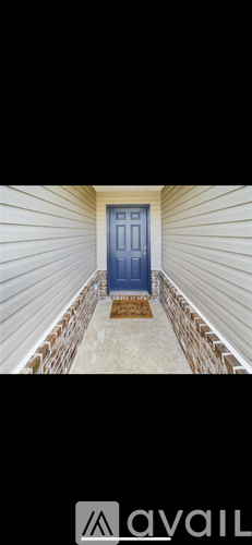A blue door is at the end of a brick-lined walkway.
