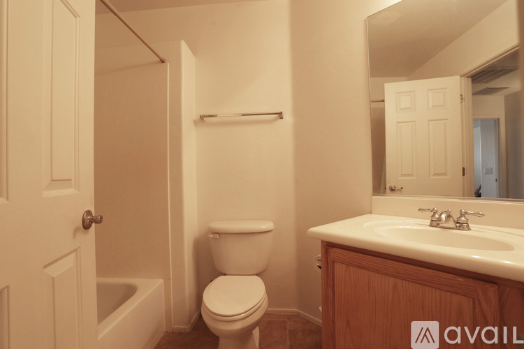 A bathroom with a toilet, sink, and bathtub.