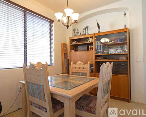 A dining room with a glass table and chairs.