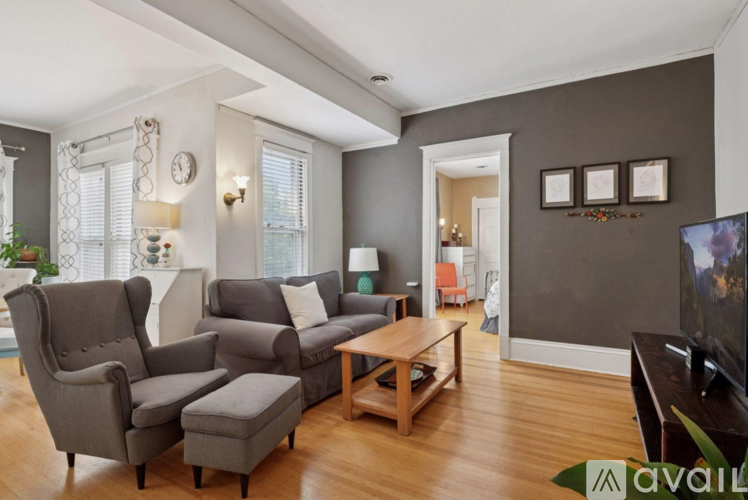 A living room with a grey couch and a wooden coffee table.