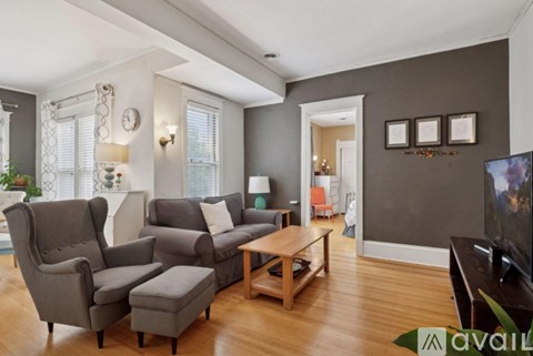 A living room with a grey couch and a wooden coffee table.