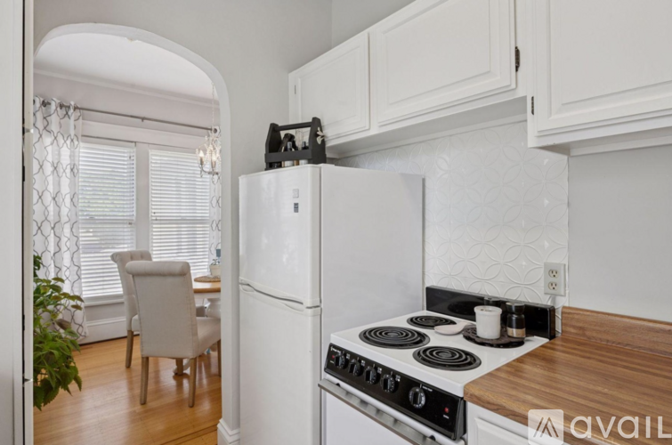 A kitchen with a white fridge and stove top oven.
