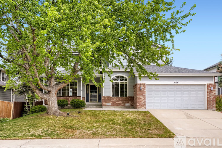 A house with a tree in front of it.