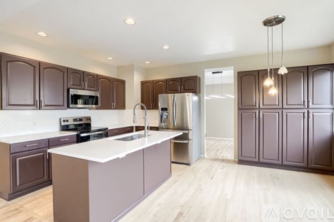 A kitchen with brown cabinets and a white countertop.