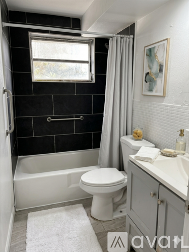 A bathroom with a white toilet, a white sink, and a white bathtub.