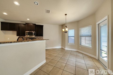 A kitchen with brown cabinets and a white countertop.