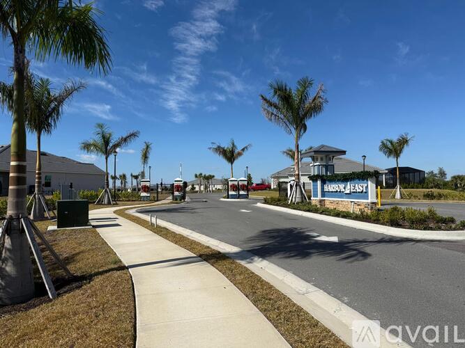 A sunny day at a suburban shopping center with palm trees lining the street.