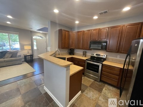 A kitchen with brown cabinets and a white island.