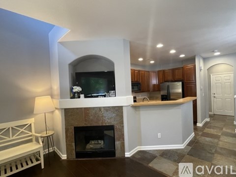 A living room with a fireplace and a television.