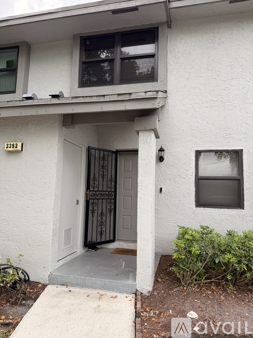 A white house with a black door and a window.