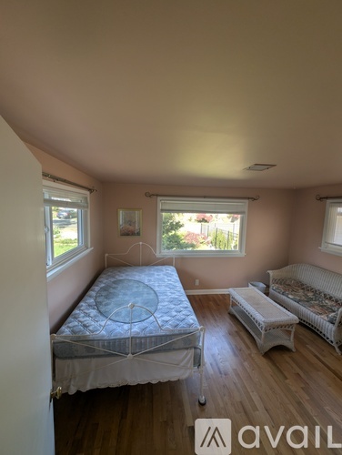 A bedroom with a bed and a couch.