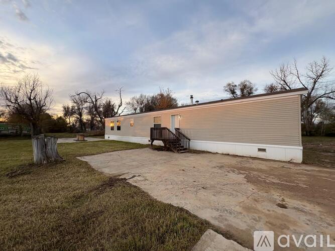 A large metal building with a ramp and a small porch.