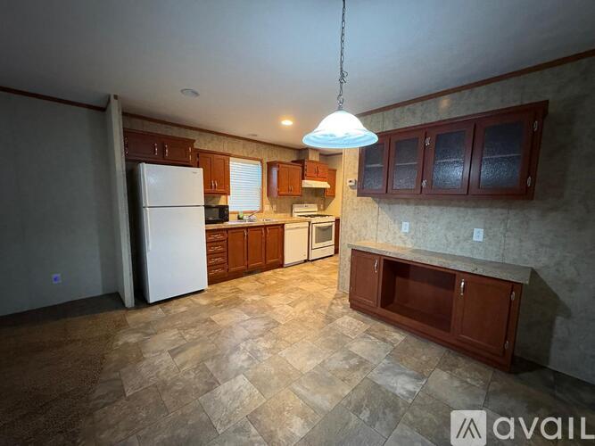 A kitchen with a tiled floor and a white refrigerator.