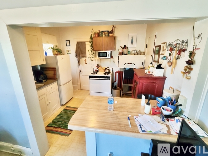 A kitchen with a white fridge and wooden countertops.