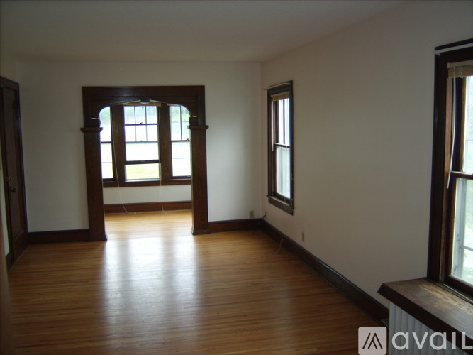 A room with wooden floors and a large window.