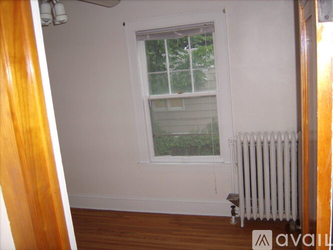 A window with a white frame and a white radiator below it.
