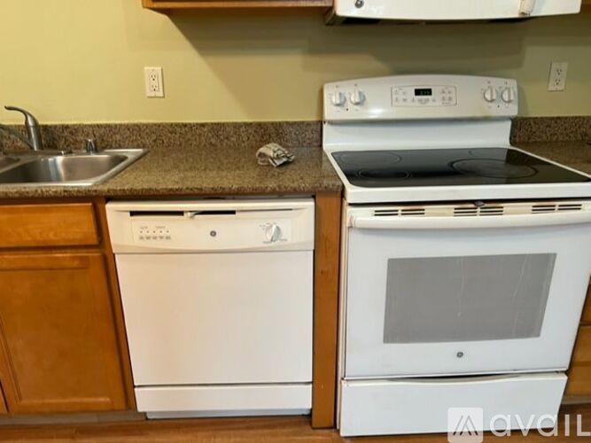A white oven and dishwasher in a kitchen.