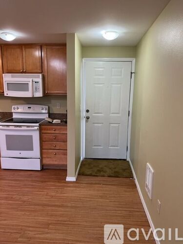 A kitchen with wooden cabinets and a white oven.