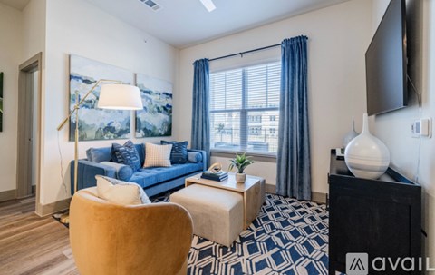 A living room with a blue couch and a yellow chair.