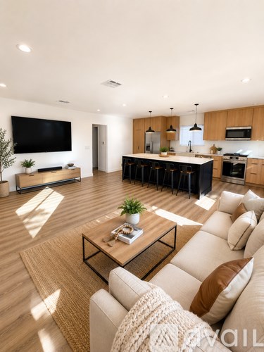 A modern living room with a large couch and a flat screen TV.