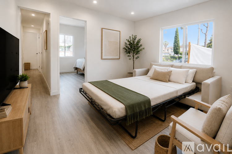 A modern bedroom with a large bed and a flat screen TV.