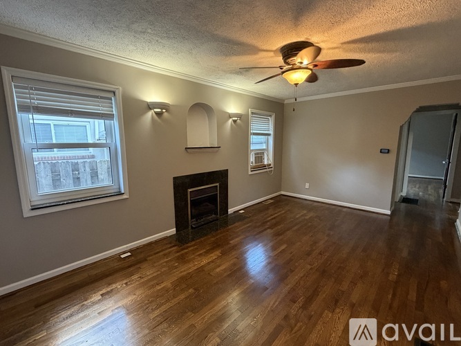 A room with a fireplace and a ceiling fan.