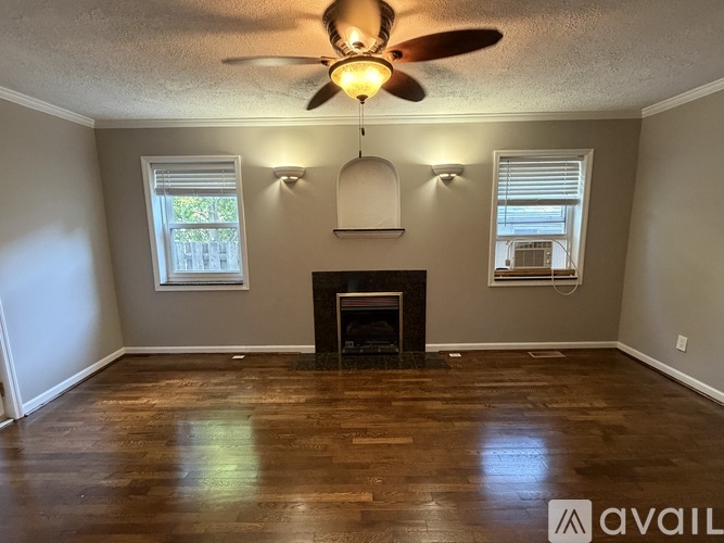 A room with a fireplace and a ceiling fan.
