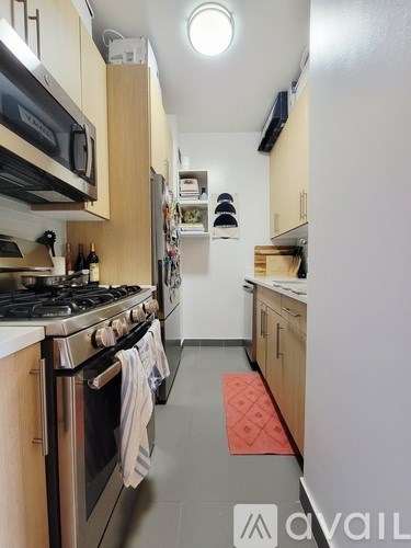 A kitchen with a stove top oven and a microwave above it.