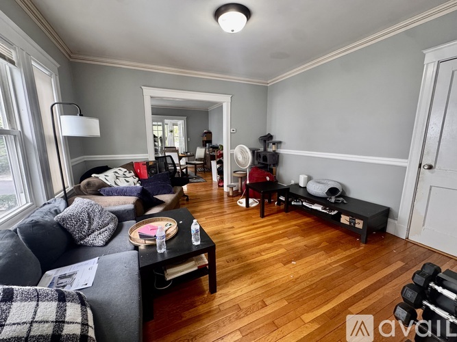 A living room with a grey couch and a black coffee table.