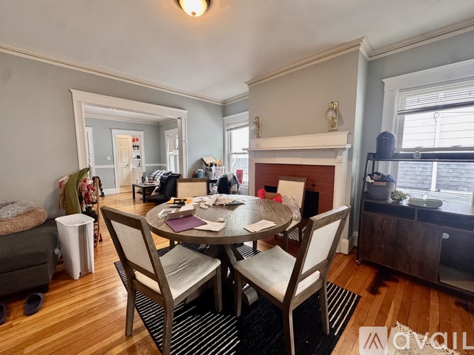 A dining room with a table and chairs.