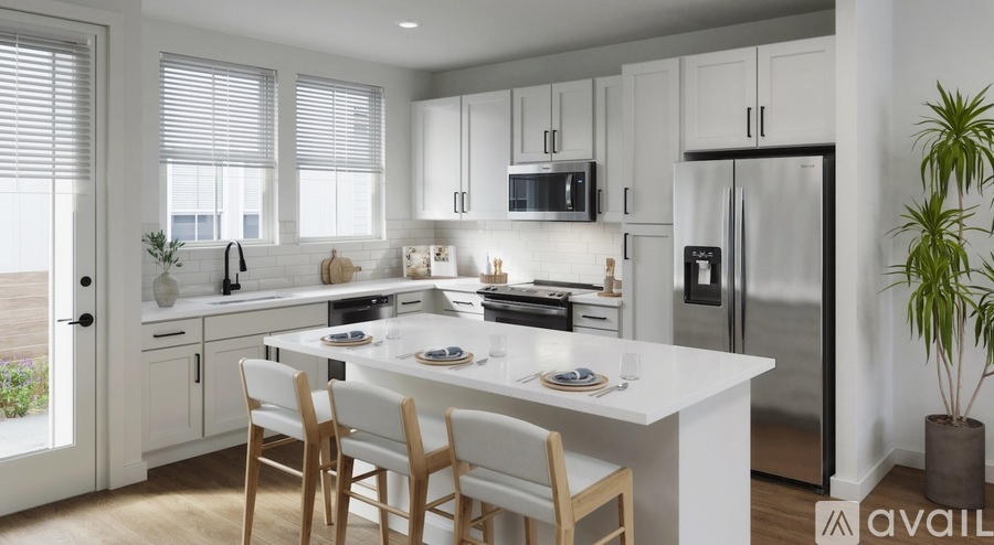 A modern kitchen with a dining table set for two.