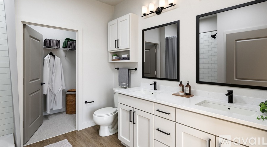A bathroom with a toilet, sink, and mirror.