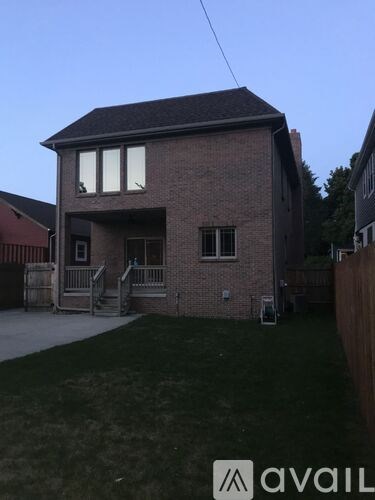 A house with a brick exterior and a pitched roof is shown.