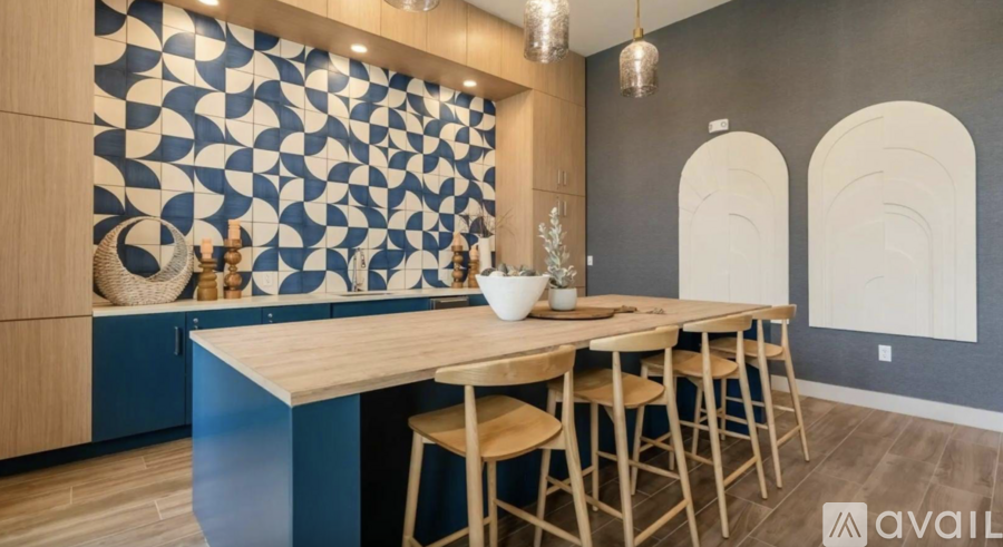 A dining area with a patterned wallpaper and wooden furniture.