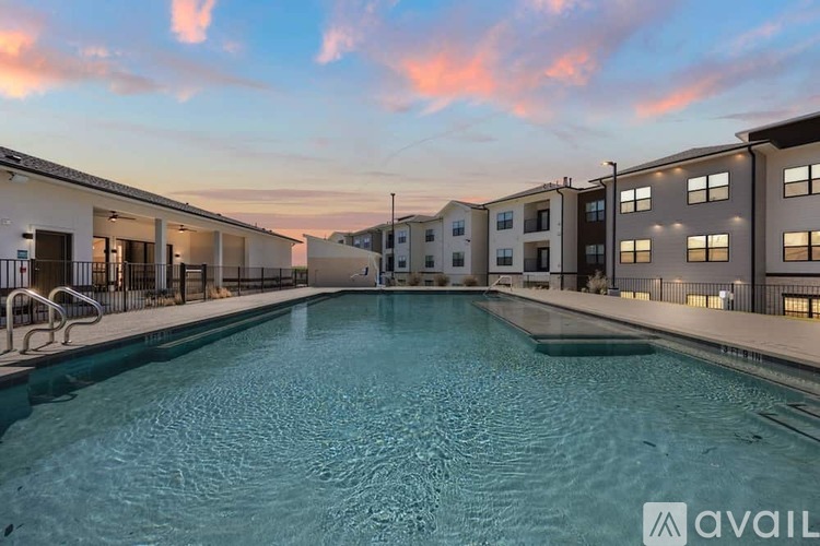 A swimming pool in a residential area with buildings in the background.
