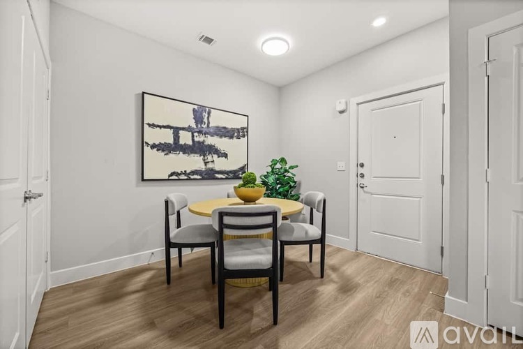 A dining room with a table set for four.