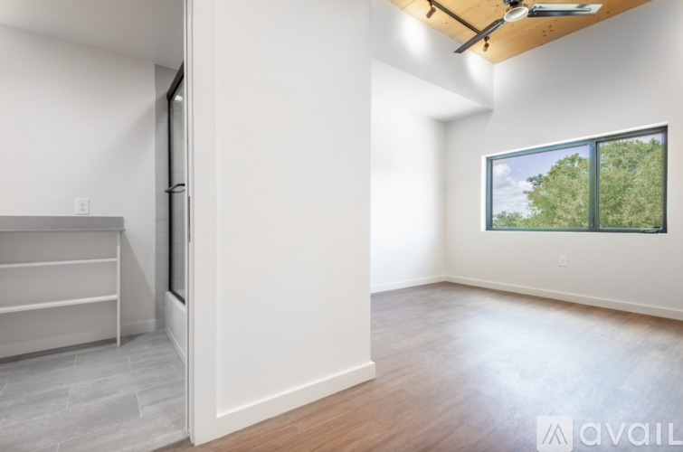 A room with a sliding door and a window overlooking trees.