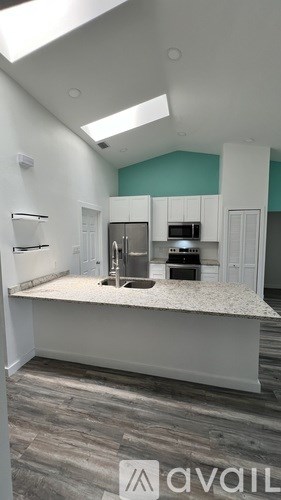 A kitchen with a countertop and cabinets is available for rent.