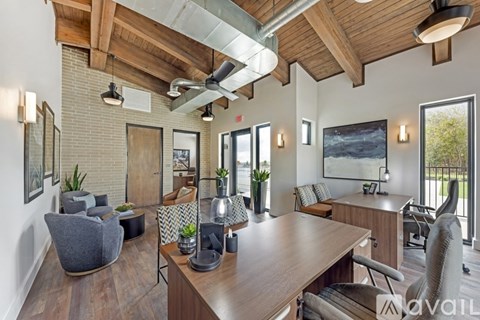 A modern living room with a wooden ceiling and a long table with chairs.