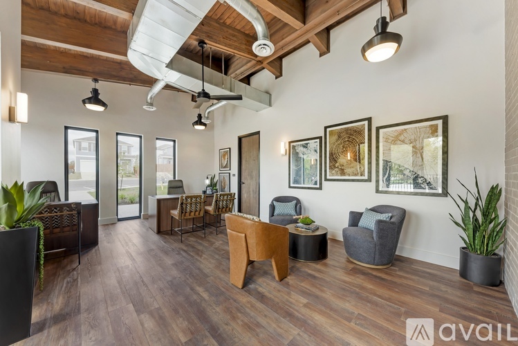 A spacious room with wooden floors and furniture.