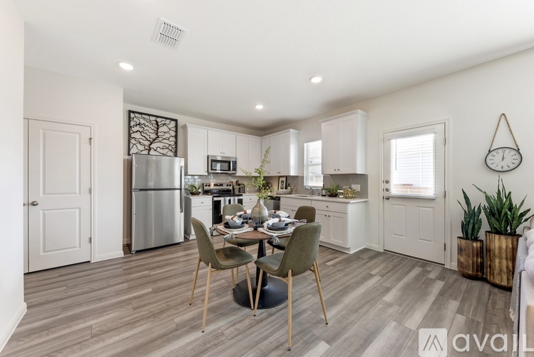 A kitchen with a table and chairs in the middle of the room.