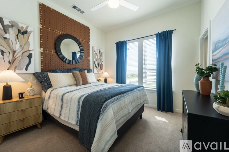 A bedroom with a large bed and a mirror on the wall.