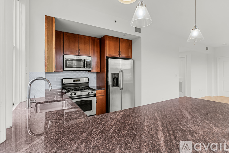 A kitchen with a refrigerator, stove, and microwave.