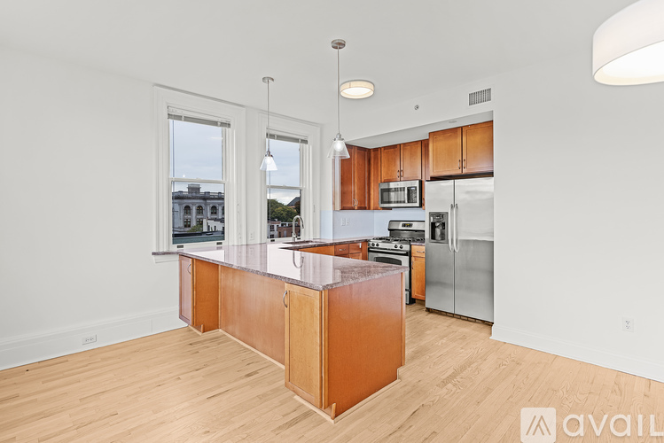A kitchen with wooden cabinets and a white countertop.