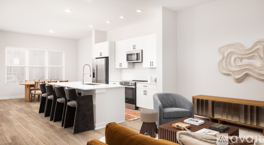 A modern kitchen with a dining table and chairs.