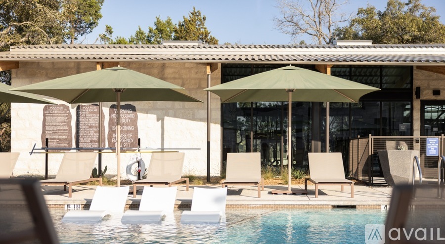 A poolside area with sun loungers and umbrellas.