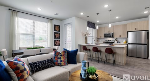 A modern living room with a grey sofa and a coffee table in the center.