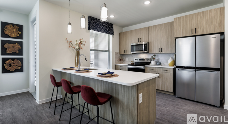 A kitchen with a bar area and chairs.