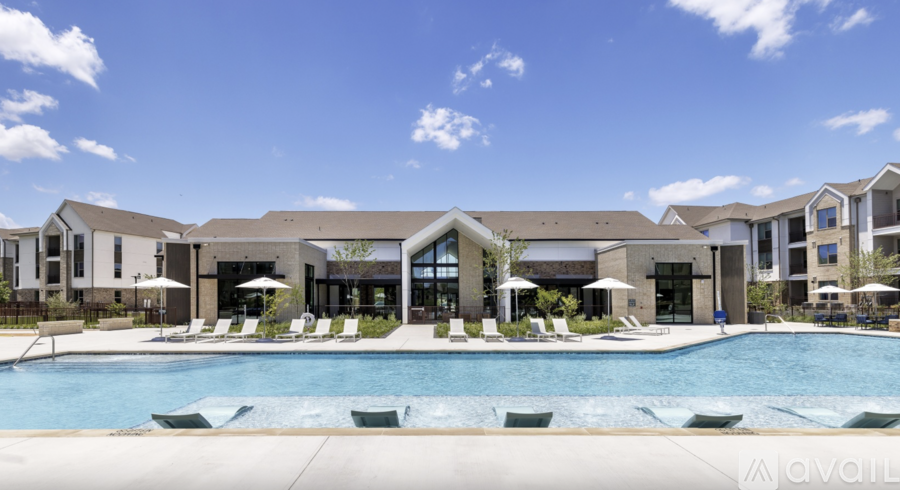 A large swimming pool in front of a resort-style building.