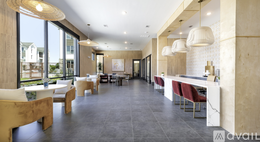 A spacious dining area with a long table and chairs.